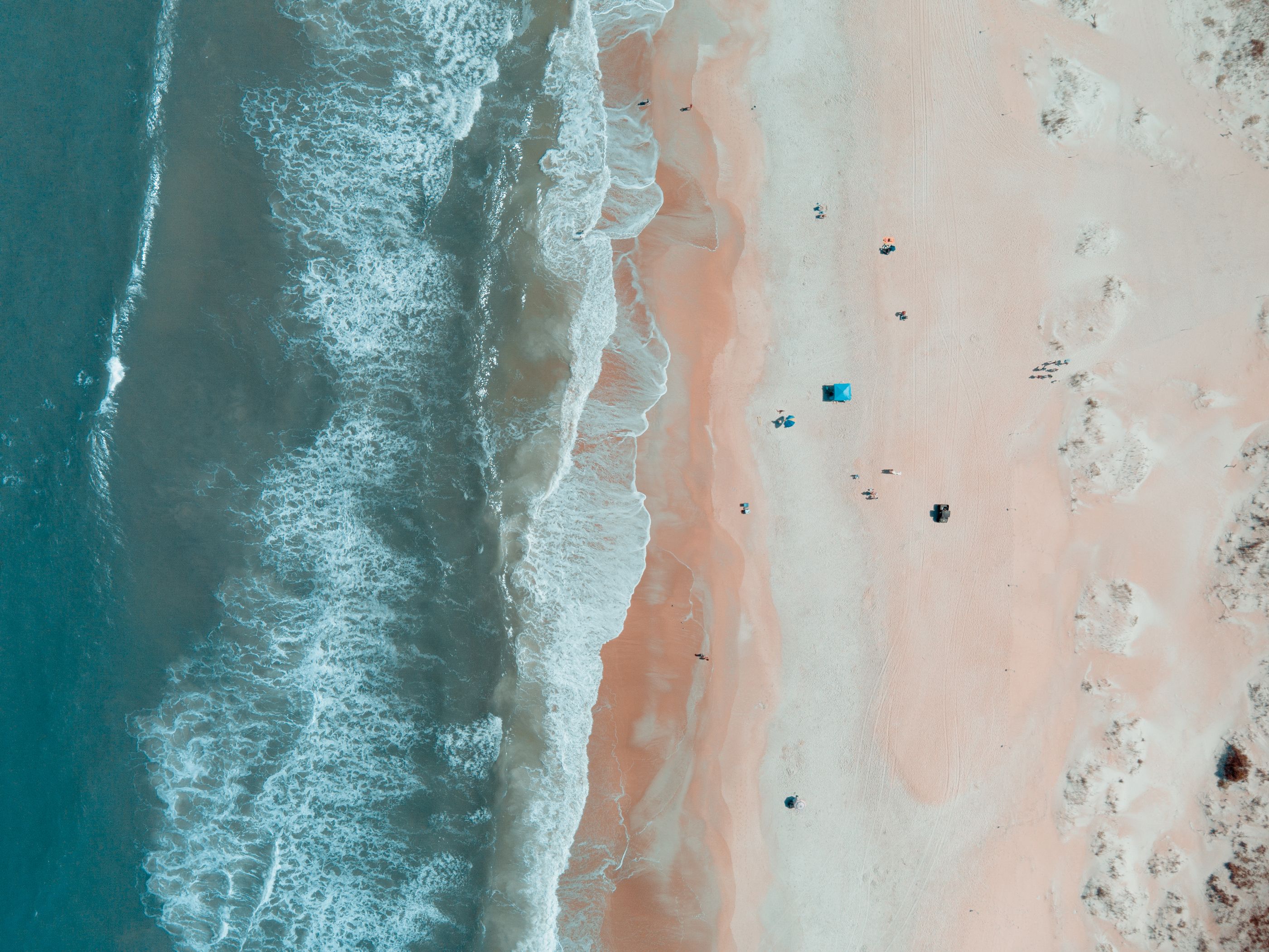 Aerial photograph of Atlantic surf meeting the sand at St. Augustine Beach